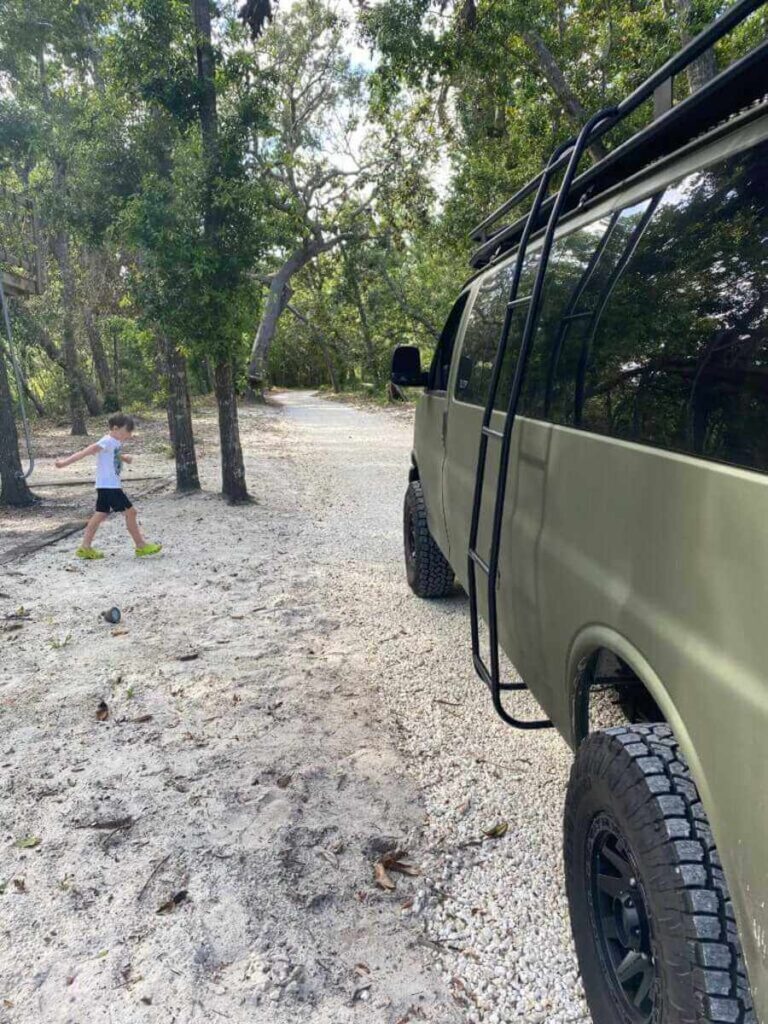 Boy walking by a Camper Van