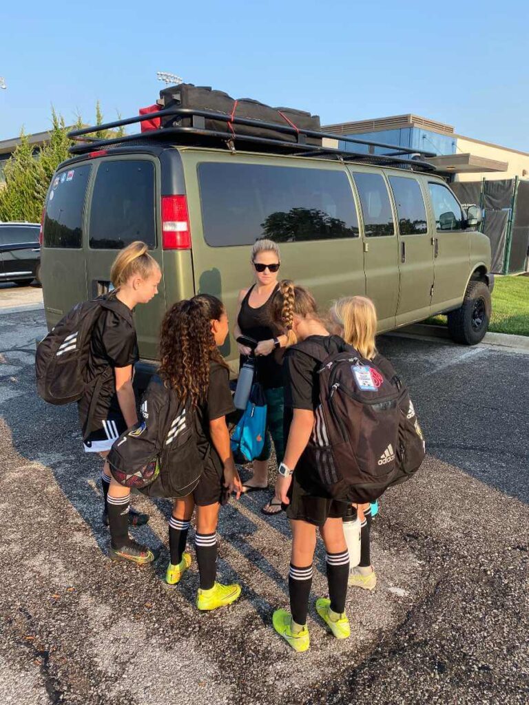 soccer-players-in-front-of-van